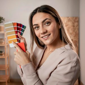 A woman holding up some color swatches